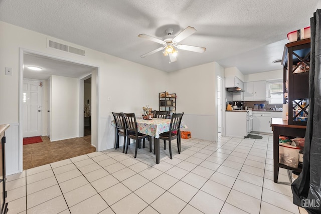 3700 Wenatchee Ave, Bakersfield, CA 93306 - dining room featuring a textured ceiling, light tile patterned flooring, a ceiling fan, and visible vents