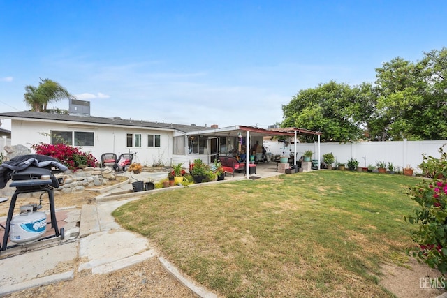 3700 Wenatchee Ave, Bakersfield, CA 93306 - back of house featuring a sunroom, a patio area, a lawn, and a fenced backyard