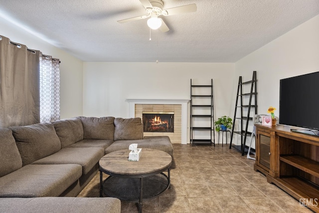 3700 Wenatchee Ave, Bakersfield, CA 93306 - living area featuring ceiling fan, a textured ceiling, and a warm lit fireplace