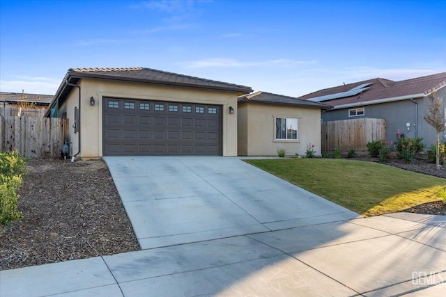 view of front of house featuring a front lawn and a garage