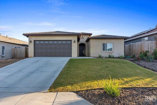 view of front of house with a garage and a front lawn