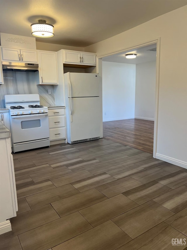 kitchen featuring under cabinet range hood, white appliances, white cabinetry, light countertops, and wood tiled floor