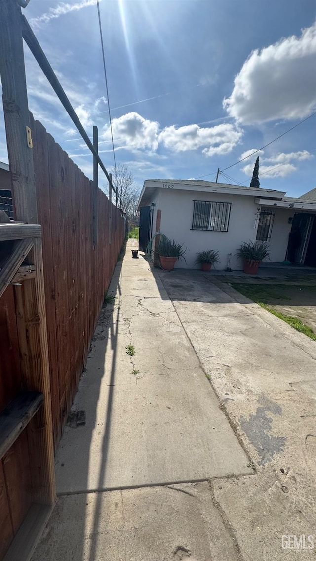 view of home's exterior featuring fence and stucco siding