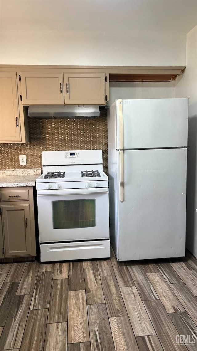 kitchen with extractor fan, white appliances, dark wood-style flooring, light countertops, and decorative backsplash