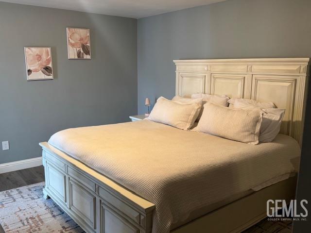 6109 Lupine Ave, Bakersfield, CA 93308 - bedroom featuring dark wood-style flooring and baseboards