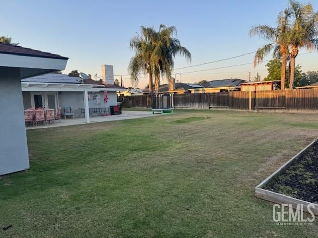 6109 Lupine Ave, Bakersfield, CA 93308 - yard at dusk featuring a patio area and french doors