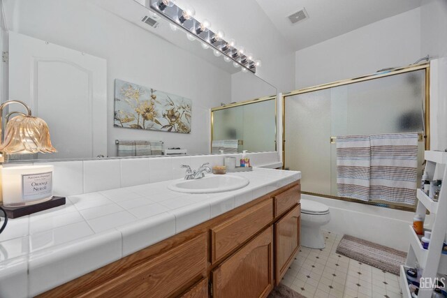 8628 Sandpines Dr, Bakersfield, CA 93312 - full bath featuring tile patterned floors, shower / bath combination with glass door, vanity, and toilet