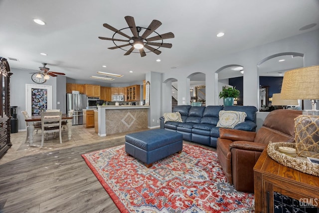 8628 Sandpines Dr, Bakersfield, CA 93312 - living area with a ceiling fan, light wood-type flooring, arched walkways, and recessed lighting
