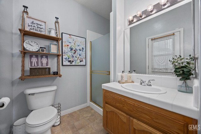 8628 Sandpines Dr, Bakersfield, CA 93312 - bathroom with a shower stall, toilet, baseboards, and vanity