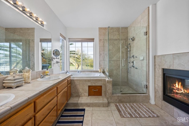 8628 Sandpines Dr, Bakersfield, CA 93312 - bathroom with a shower stall, tile patterned flooring, a fireplace, a garden tub, and double vanity