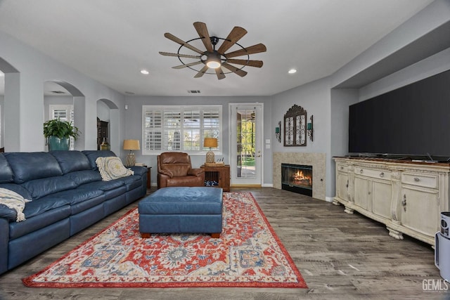 8628 Sandpines Dr, Bakersfield, CA 93312 - living room featuring a ceiling fan, wood finished floors, recessed lighting, a fireplace, and baseboards