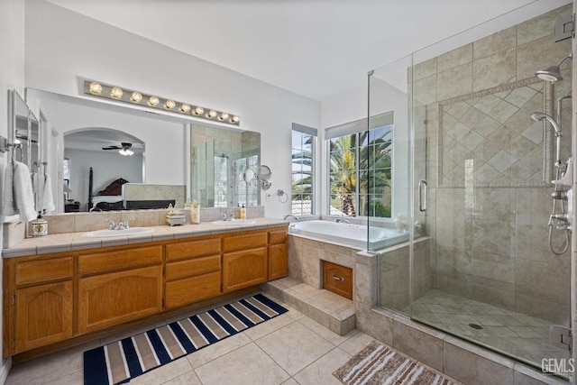 8628 Sandpines Dr, Bakersfield, CA 93312 - ensuite bathroom featuring tile patterned floors, a shower stall, a bath, double vanity, and a ceiling fan