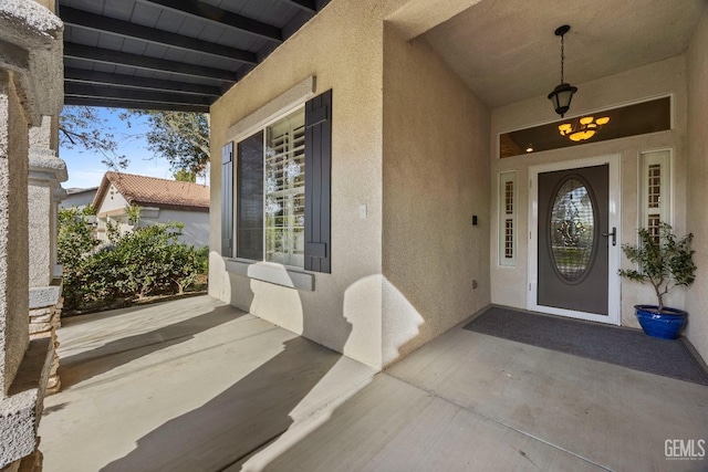 8628 Sandpines Dr, Bakersfield, CA 93312 - view of exterior entry with stucco siding and a porch