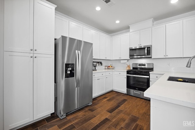 3116 Seymour St, Tulare, CA 93274 - kitchen with stainless steel appliances, a sink, dark wood finished floors, recessed lighting, and light countertops