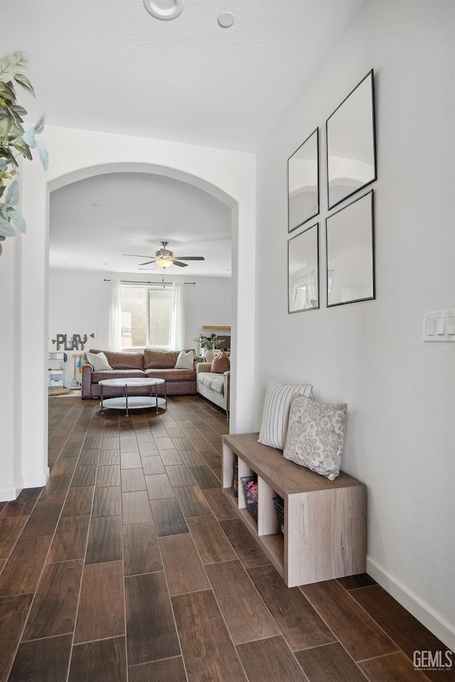 3116 Seymour St, Tulare, CA 93274 - living room featuring arched walkways, dark wood-style floors, and a ceiling fan