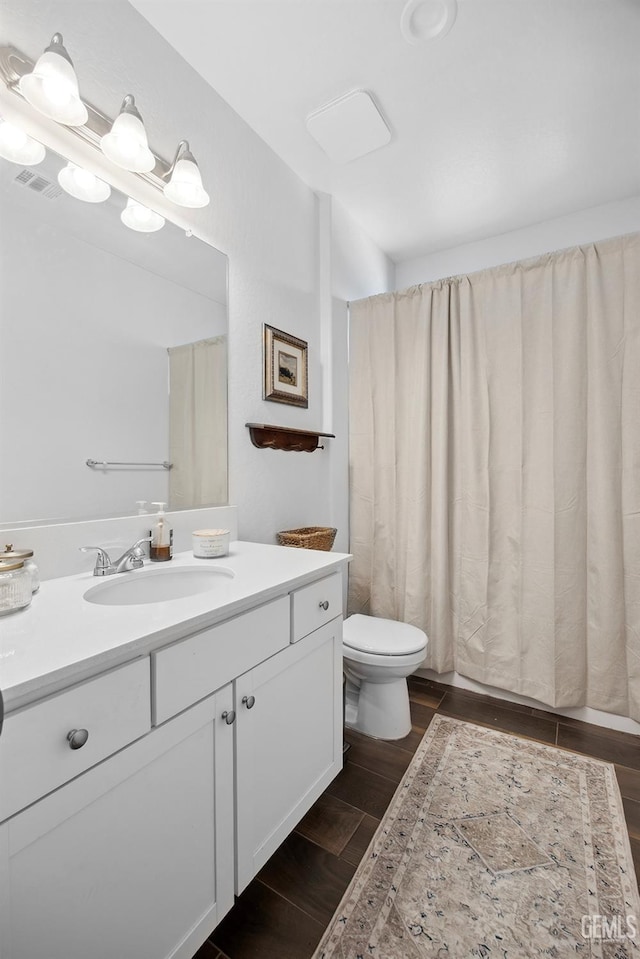 3116 Seymour St, Tulare, CA 93274 - full bath featuring wood finished floors, vanity, and toilet