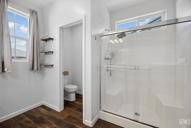 3116 Seymour St, Tulare, CA 93274 - full bath with a shower stall, wood finish floors, toilet, and baseboards