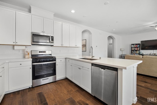 3116 Seymour St, Tulare, CA 93274 - kitchen featuring stainless steel appliances, a sink, arched walkways, a peninsula, and recessed lighting