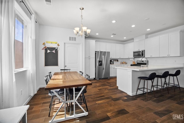 3116 Seymour St, Tulare, CA 93274 - kitchen with stainless steel appliances, a peninsula, a chandelier, recessed lighting, and light countertops