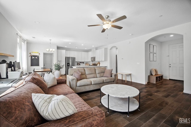 3116 Seymour St, Tulare, CA 93274 - living room with arched walkways, ceiling fan, recessed lighting, dark wood-style flooring, and baseboards