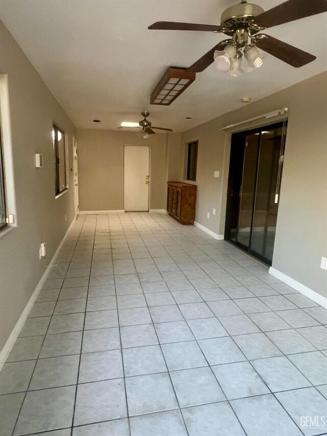 1325 Bayne Ct, Bakersfield, CA 93307 - empty room with a ceiling fan and light tile patterned flooring