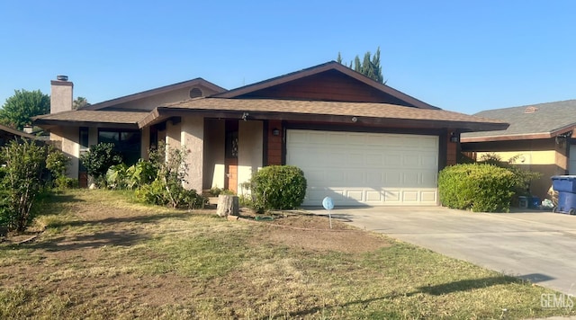 1325 Bayne Ct, Bakersfield, CA 93307 - ranch-style home with an attached garage, driveway, a chimney, and roof with shingles