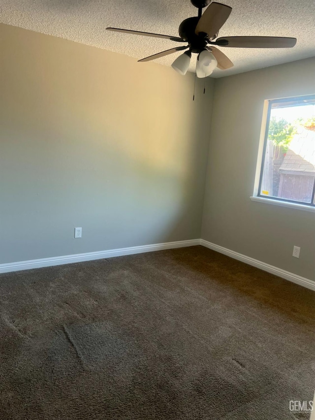 1325 Bayne Ct, Bakersfield, CA 93307 - spare room featuring a textured ceiling, ceiling fan, and dark carpet
