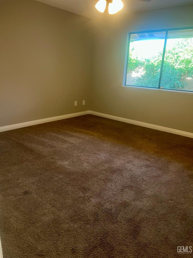 1325 Bayne Ct, Bakersfield, CA 93307 - unfurnished room with dark colored carpet and ceiling fan