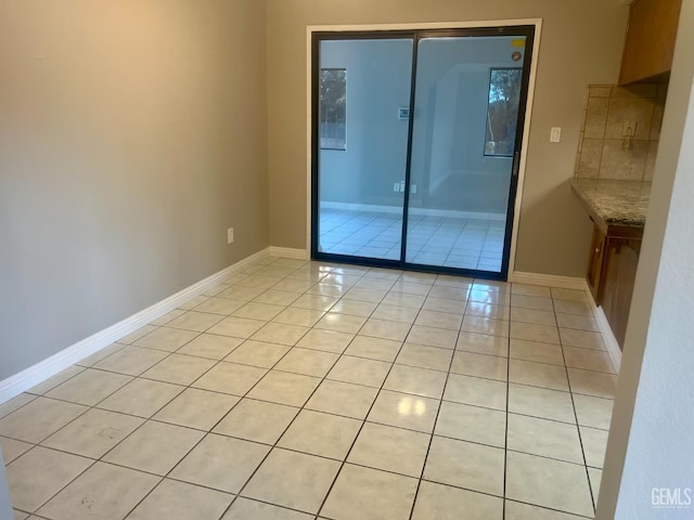 1325 Bayne Ct, Bakersfield, CA 93307 - unfurnished room featuring light tile patterned floors and baseboards