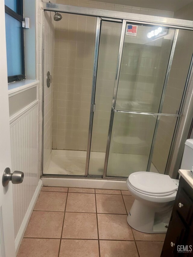 1325 Bayne Ct, Bakersfield, CA 93307 - full bathroom featuring a stall shower, vanity, and tile patterned flooring