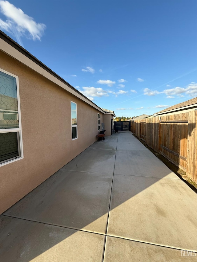 view of side of property with a patio