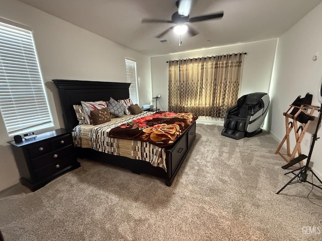 bedroom with ceiling fan and light carpet