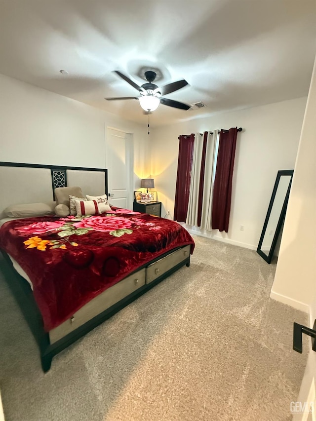 bedroom featuring ceiling fan and carpet