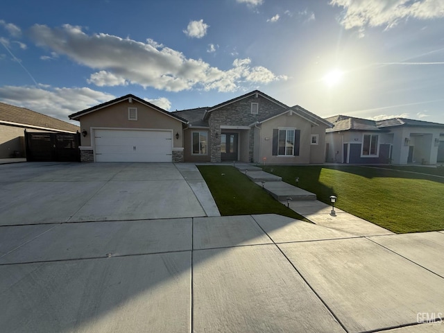 ranch-style home featuring a garage and a front lawn