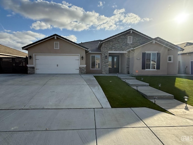 ranch-style house featuring a garage and a front lawn