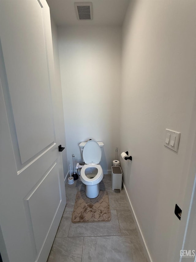 bathroom featuring tile patterned flooring and toilet