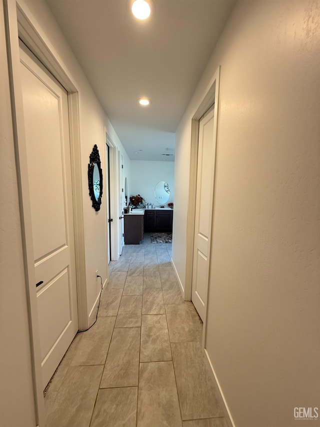 hall with light tile patterned floors