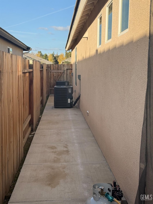 view of side of home featuring central AC unit