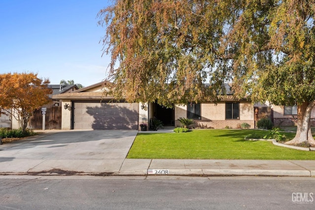 view of property hidden behind natural elements featuring a front yard and a garage