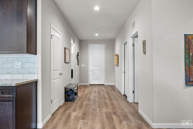 hall featuring recessed lighting, visible vents, light wood finished floors, and baseboards