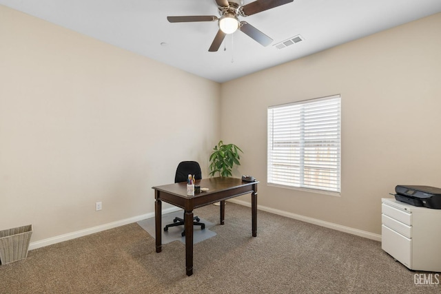 office featuring light carpet, baseboards, visible vents, and ceiling fan