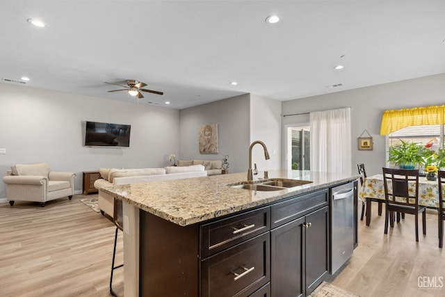 kitchen with dishwasher, visible vents, a sink, light wood-style flooring, and ceiling fan