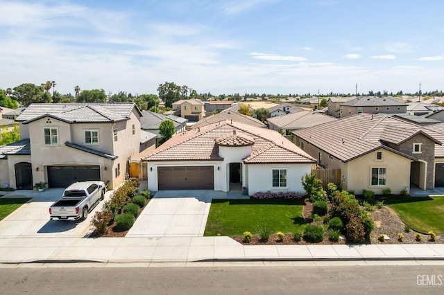 mediterranean / spanish-style home with a front lawn, a residential view, concrete driveway, and stucco siding