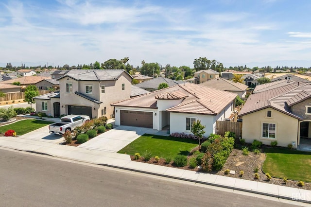view of front of house with fence, a residential view, stucco siding, a tile roof, and driveway