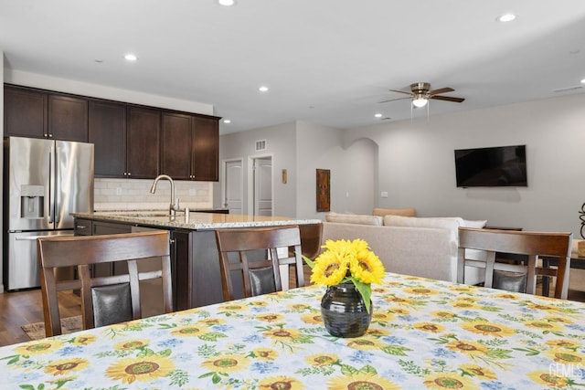 kitchen featuring recessed lighting, stainless steel fridge, dark brown cabinetry, and ceiling fan