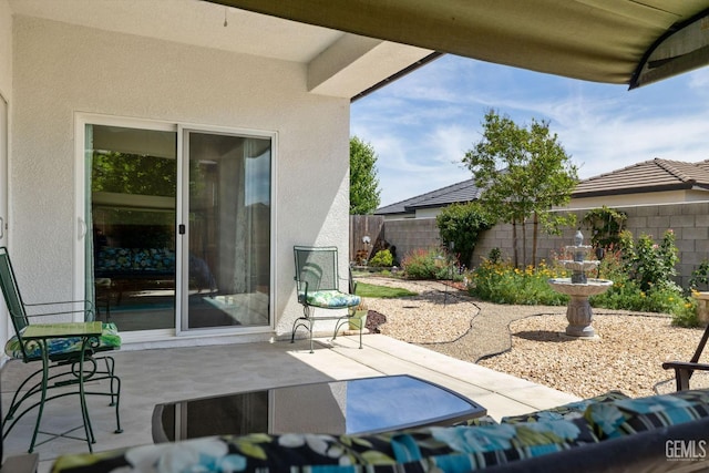 view of patio featuring fence