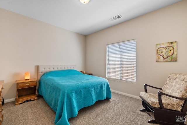 carpeted bedroom featuring baseboards and visible vents