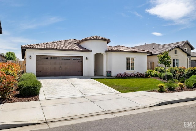 mediterranean / spanish-style house featuring a tiled roof, a front lawn, stucco siding, concrete driveway, and a garage