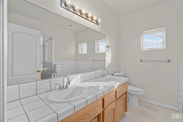 408 Brite Meadow Ct, Bakersfield, CA 93308 - bathroom featuring toilet, plenty of natural light, double vanity, and a shower with door