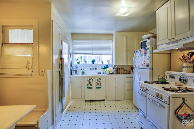 512 N Harper Ave, Los Angeles, CA 90048 - kitchen with white appliances, under cabinet range hood, light floors, and white cabinetry
